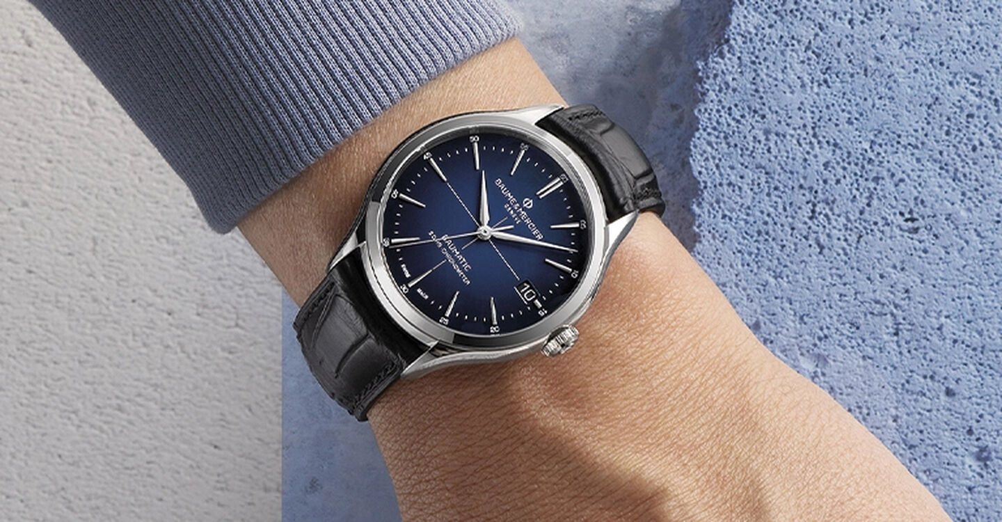 Baume & Mercier Clifton watch on a man's wrist.